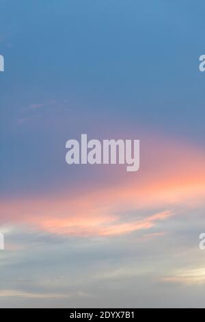 sky and cloud in blue and orange gradient colors. Colorful smooth sky in dusk. Stock Photo