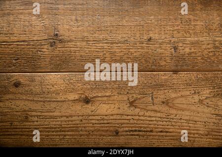 Background texture of two natural brown wood or timber planks with woodgrain pattern and knots in a close up on the surface in full frame Stock Photo