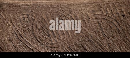 Field plowed with tractor tracks, top view Stock Photo