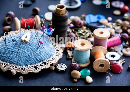 Close up of sewing pins, retro threads and beads assortment Stock Photo