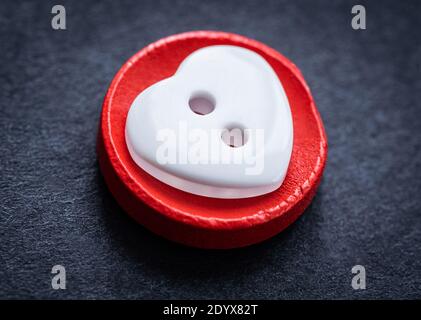 Top view of heart shaped sewing button macro Stock Photo