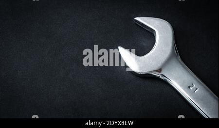 Metallic hand wrench on dark background with copy space Stock Photo