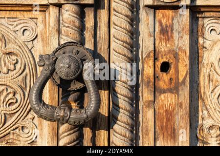 Ornamental door knocker on old carved wood panel door close up detail of the historic St. Alexander Nevsky Orthodox Cathedral church in Sofia Bulgaria Stock Photo