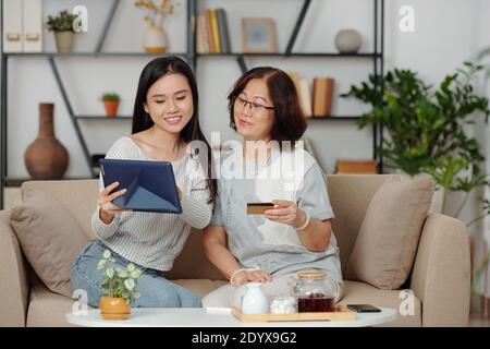 Shopping online with mother Stock Photo