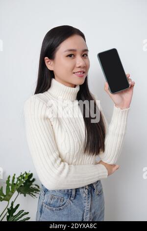 Young woman showing smartphone Stock Photo