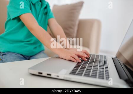 Boy typing on laptop Stock Photo