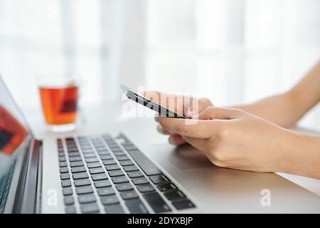 Checking notifications on smartphone Stock Photo