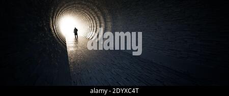 Concept or conceptual dark tunnel with a bright light at the end or exit as metaphor to success, faith, future or hope to new opportunity or freedom Stock Photo
