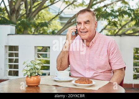 Senior man eating breakfast Stock Photo