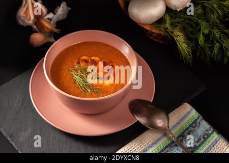 Delicious mushroom soup with dill and fried toast on the table. Top horizontal top view Stock Photo