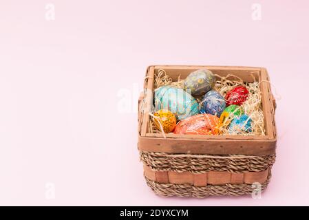 Colorful Easter eggs on pink background with copy space Stock Photo