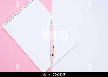 pink pen over note book on white background Stock Photo