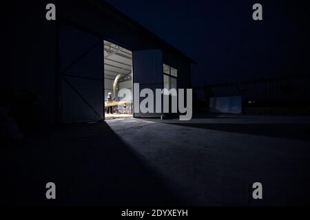 (201228) -- YINCHUAN, Dec. 28, 2020 (Xinhua) -- Li Yaomei makes brooms after work at the factory in Longyuan Village of Hongsibao District in Wuzhong City, northwest China's Ningxia Hui Autonomous Region, Oct. 26, 2020. Xihaigu, a largely mountainous region in central-southern Ningxia, was once inflicted by deep poverty and labeled the 'most unfit place for human settlement' by the United Nations in the 1970s due to land reclamation, drought, and a fragile ecological environment. On Nov. 16, 2020, Xihaigu historically bid farewell to absolute poverty, during which 'she power' played an indispe Stock Photo