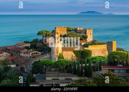 View over the castle, the town and the harbour of Castiglione della Pescaia to the island of Giglio in the Tyrrhenian Sea at sunset,  Tuscany, Italy Stock Photo