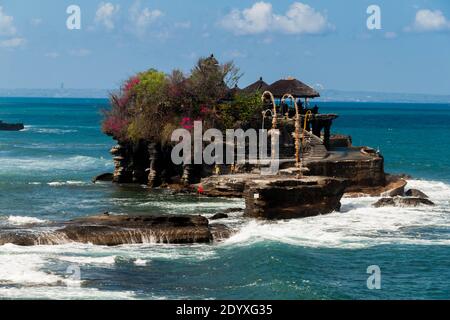 Tanah Lot Temple, one of the most famous landmarks of Bali, in the wavy ocean Stock Photo