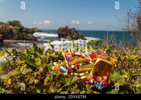 Daily Canang Sari offerings made by Balinese Hindus in front of Tanah Lot Temple in Bali Stock Photo