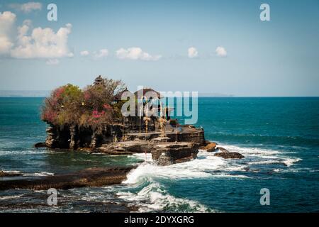 Tanah Lot Temple, one of the most famoous landmarks in Bali, in the wavy sea Stock Photo