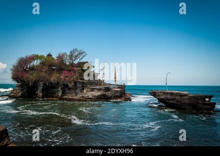 The ancient Hindu pilgrimate temple, Tanah Lot, in the wavy sea Stock Photo