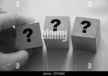 Questions Marks on wooden cubes. FAQ Information, Communication and Brainstorming Concepts. Stock Photo