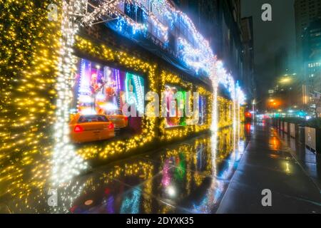 Saks Fifth Avenue Christmas window displays glow in the dawn on Christmas 2020. Stock Photo