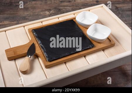 empty cheese serving Board on wooden rustic background. empty wooden tray for breakfast. board for filing sushi or cheese Stock Photo