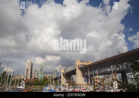 Vancouver, Canada - June 29 2014: Burrard St. Bridge in Vancouver on a sunny day with puffy clouds. The Art Deco style bridge was constructed from 193 Stock Photo