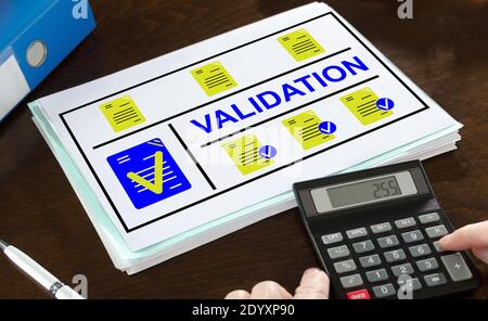 Validation concept illustrated on a paper with a calculator Stock Photo