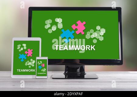 Teamwork concept shown on different information technology devices Stock Photo