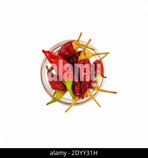 Dry red hot pepper in a glass bowl, isolated on a white background. The view from the top Stock Photo