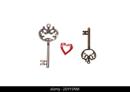 Two vintage keys and a red heart isolated on a white background Stock Photo