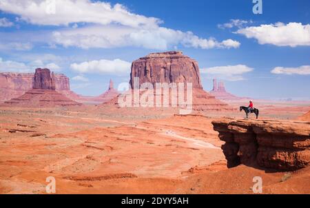 Navajo man in red shirt and cowboy hat on a horse John Ford's Point Lone Horse Rider at Merrick Butte, Monument Valley Navajo Tribal Park Arizona USA Stock Photo