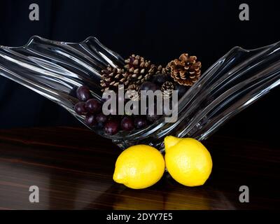 Study in Still Life of 1950's rippled and winged glass fruit bowl or vase. Interior Design Ornament. Study in natural reflective lighting. Stock Photo