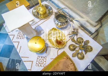 chalice for wine, blood of christ, and ciborium with host, body of christ, and ampoules with wine and water for the consecration on the others of the Stock Photo