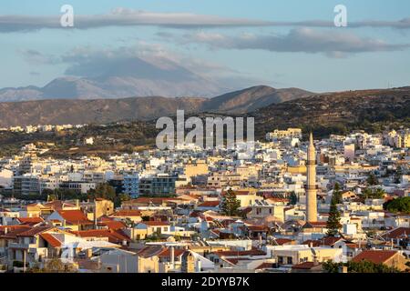 Citsycape view of Rethymno at sunset as seen from Fortezza Castle, showing the minaret of Neratze Mosque, Crete, Greece Stock Photo