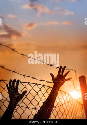 Refugee men and fence , immigration concept Stock Photo