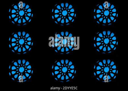 Nine blue lights in the shape of an abstract circles on a black background. Stock Photo