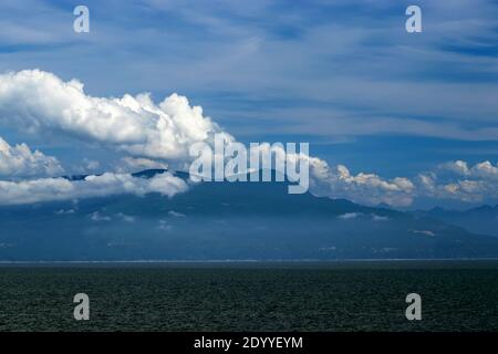 Clouds reflect sunshine over the Pacific Ocean, BC, Canada. Pacific ocean borders Western Canada. British Columbia's coastal weather is shaped by the Stock Photo