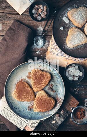 Culinary background with cookies in the shape of hearts on a vintage background. Stock Photo