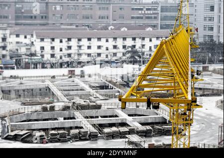Unusual angle, close-up view at yellow crane boom at construction site in China Stock Photo