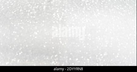 Defocused shining silver bokeh texture. Holiday background Stock Photo