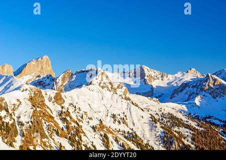 Dolomites mountain range at dusk, around Colac-Buffaure subgroup that forms part of the Marmolada group, Trentino, Italy in winter season with snow