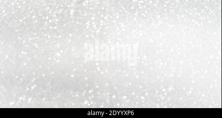 Defocused shining silver bokeh texture. Holiday background Stock Photo