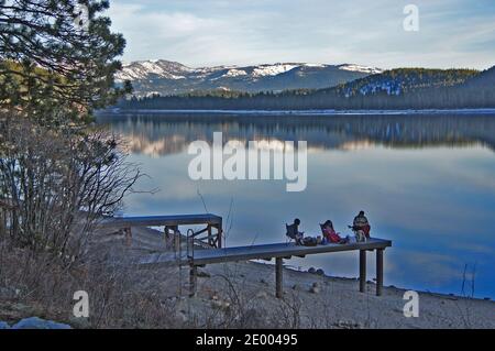 scenic view of reflection  on  donner lake california of family relaxing on pierat sunset in sierra nevada usa Stock Photo