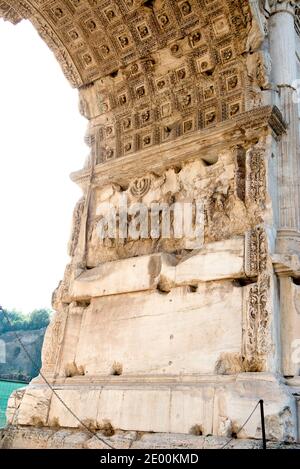 Detail of the Golden Menorah in the Arch of Titus, located on the Via Sacra, just to the south-east of the Roman Forum in Rome, Italy, which was built to commemorate Titus's victory in Judea, depicts a Roman victory procession with soldiers carrying spoils from the Temple, including the Menorah, which were used to fund the construction of the Colosseum, on Wednesday, October 23, 2013. It was constructed c. 82 AD by the Roman Emperor Domitian shortly after the death of his older brother Titus to commemorate Titus' victories, including the Siege of Jerusalem in 70 AD. The Arch is said to have pr Stock Photo