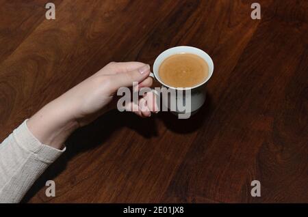 Taking a cup of coffee in the morning Stock Photo