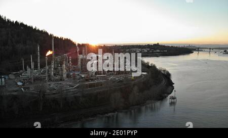 A aerial hyperlapse of an oil refinery in Burrard Inlet with a view of downtown Vancouver, Canada, in the background.