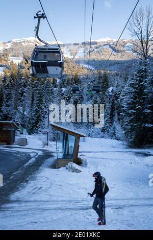 WHISTLER, BC, CANADA - DEC 27, 2020: Blackcomb gondola with skiier walking in front. Stock Photo