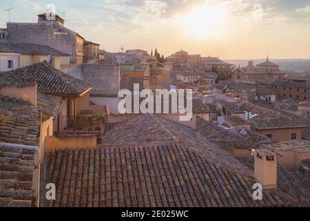 Golden light of a setting sun over terracotta rooftops in Toledo, Spain Stock Photo