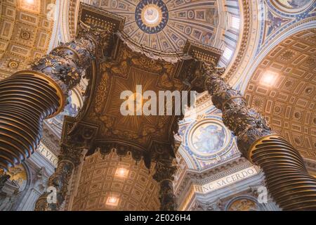 Vatican, Vatican City - November 5 2014: Looking up at the Bernini's Baldacchino commissioned by Pope Urban VIII in 1623. It's placed over the high al Stock Photo