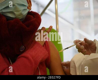Rome, Italy. 28th Dec, 2020. A woman receives an injection of the COVID-19 vaccine at the San Filippo Neri Hospital in Rome, Italy, Dec. 28, 2020. Credit: Alberto Lingria/Xinhua/Alamy Live News Stock Photo